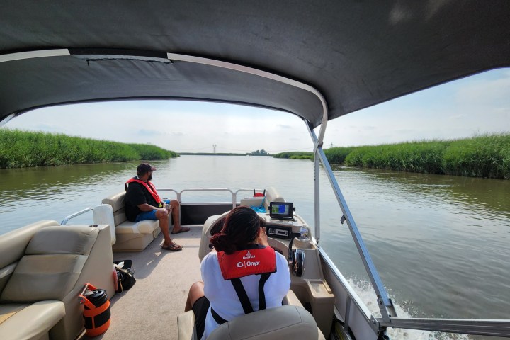 a group of people in a boat on a body of water