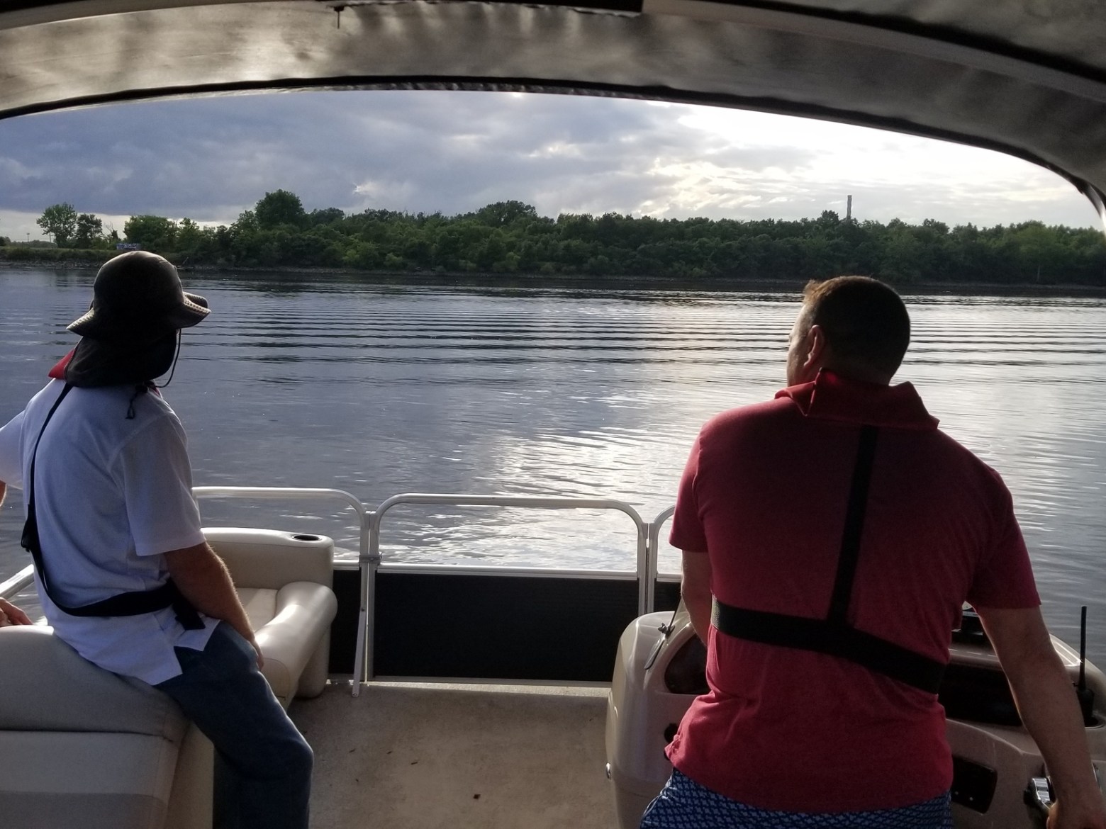 a man and a woman sitting on a boat in the water